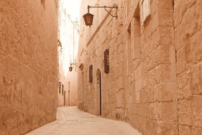 Empty alley amidst buildings