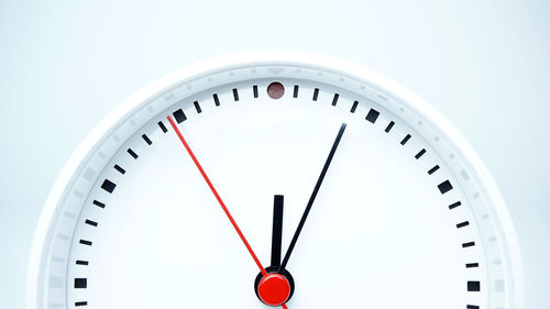 Close-up of clock over white background