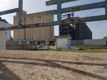 View of construction site by building against sky