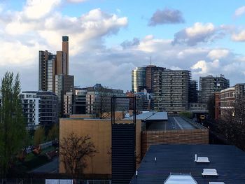 View of skyscrapers against cloudy sky