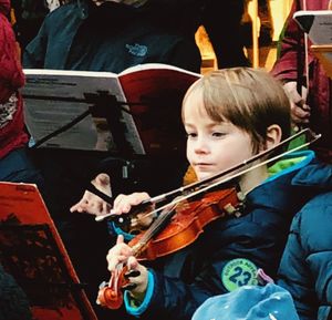 High angle view of girl playing at music concert