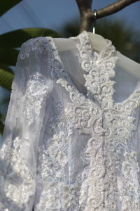 Close-up of white flowers hanging on fabric