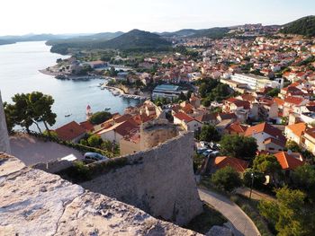 High angle view of townscape by sea
