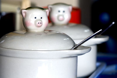 Pig shaped lids on porcelain containers