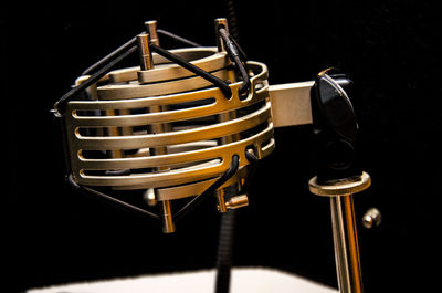 Close-up of electric lamp against black background