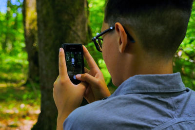 Midsection of man using mobile phone