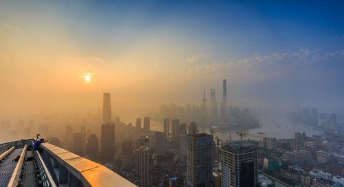 Scenic view of cityscape in foggy weather