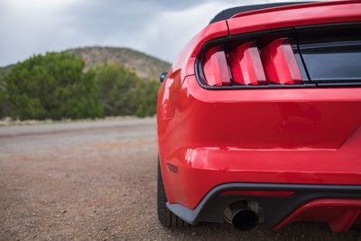 Close-up of red car on road against sky