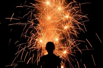 Low angle view of firework display at night