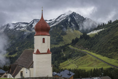 Panoramic view of building and mountains against sky