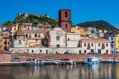 Buildings in town against clear sky