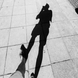 Low section of man standing on tiled floor