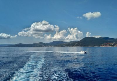 Scenic view of sea and boats against sky during ferry traveling