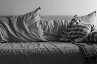 Midsection of man relaxing on bed at home