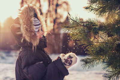 Child  in park during winter above sunshine 