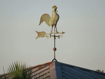 Low angle view of weather vane