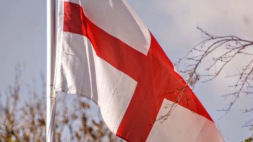 Low angle view of flag against sky