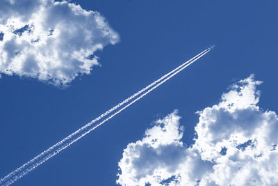 Low angle view of vapor trails in sky