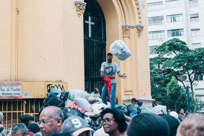 People standing on street against building