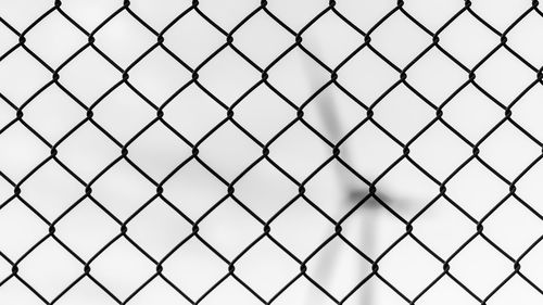 Full frame shot of chainlink fence against sky