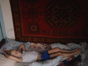 High angle view of woman sleeping on bed at home