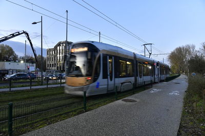 Tramway on railroad track against sky