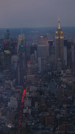 Aerial view of buildings in city at dusk