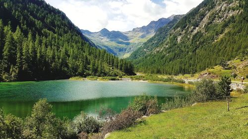 Scenic view of lake and mountains against sky