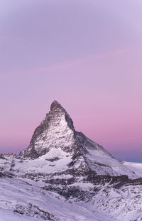 Close-up of snow against sky during sunset