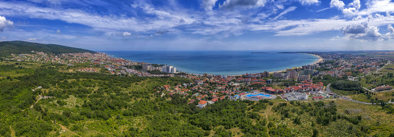 High angle view of townscape by sea against sky