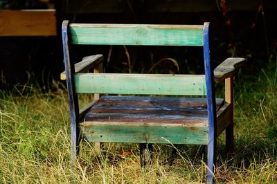 Empty bench in field