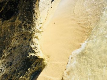 High angle view of wave flowing on shore at beach