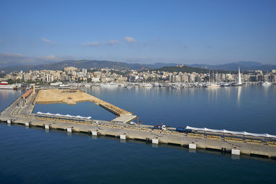 Bridge over sea against buildings in city