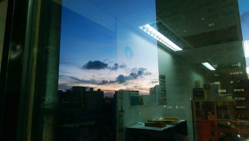 Buildings in city seen through glass window