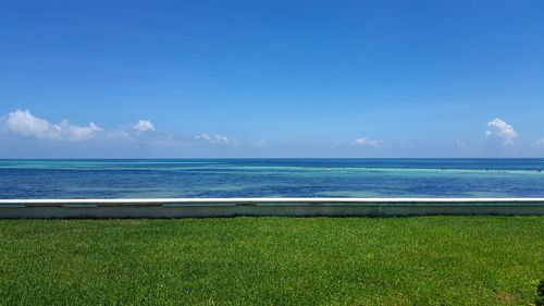 Scenic view of sea against blue sky