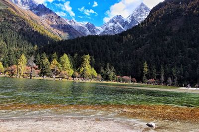 Scenic view of lake by mountain against sky