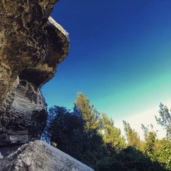 Low angle view of rock formation against clear blue sky