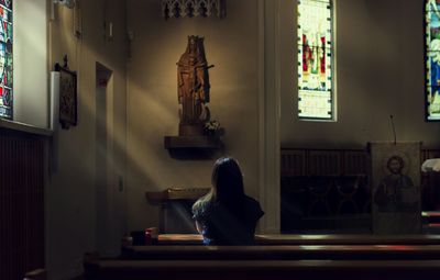 Rear view of woman sitting in church