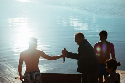 Fishermen sharing a fish