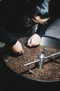 High angle view of hand holding coffee cup