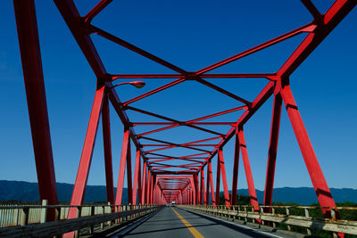 Low angle view of bridge against clear blue sky