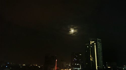 Low angle view of skyscrapers lit up at night