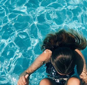 High angle view of woman swimming in pool