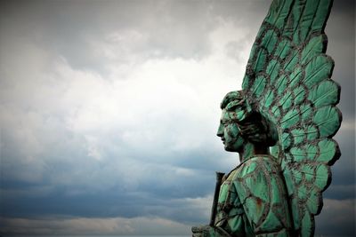 Low angle view of statue against sky