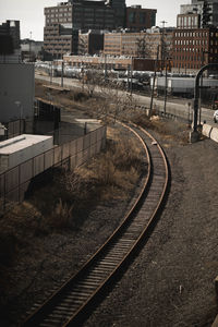 High angle view of railroad tracks by buildings in city