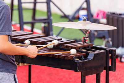 A sideline percussionist performing at an outdoors rehearsal