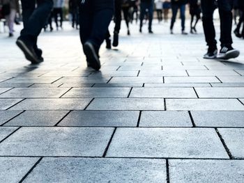 Low section of people walking on footpath