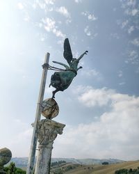 Low angle view of statue against sky