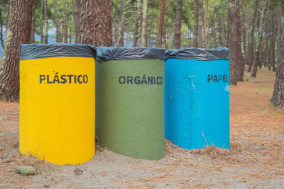 Close-up of sign board on tree trunk in forest