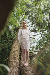 Full length of woman standing against plants